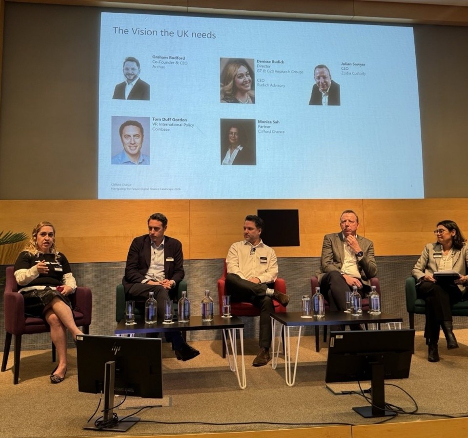 Vision in the UK Panel Fiver person panel sat on a stage with their pictures and bios on a screen behind them